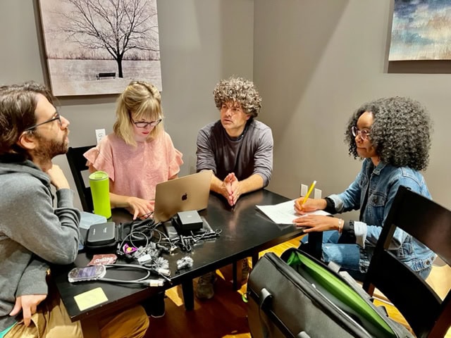 people working over a desk